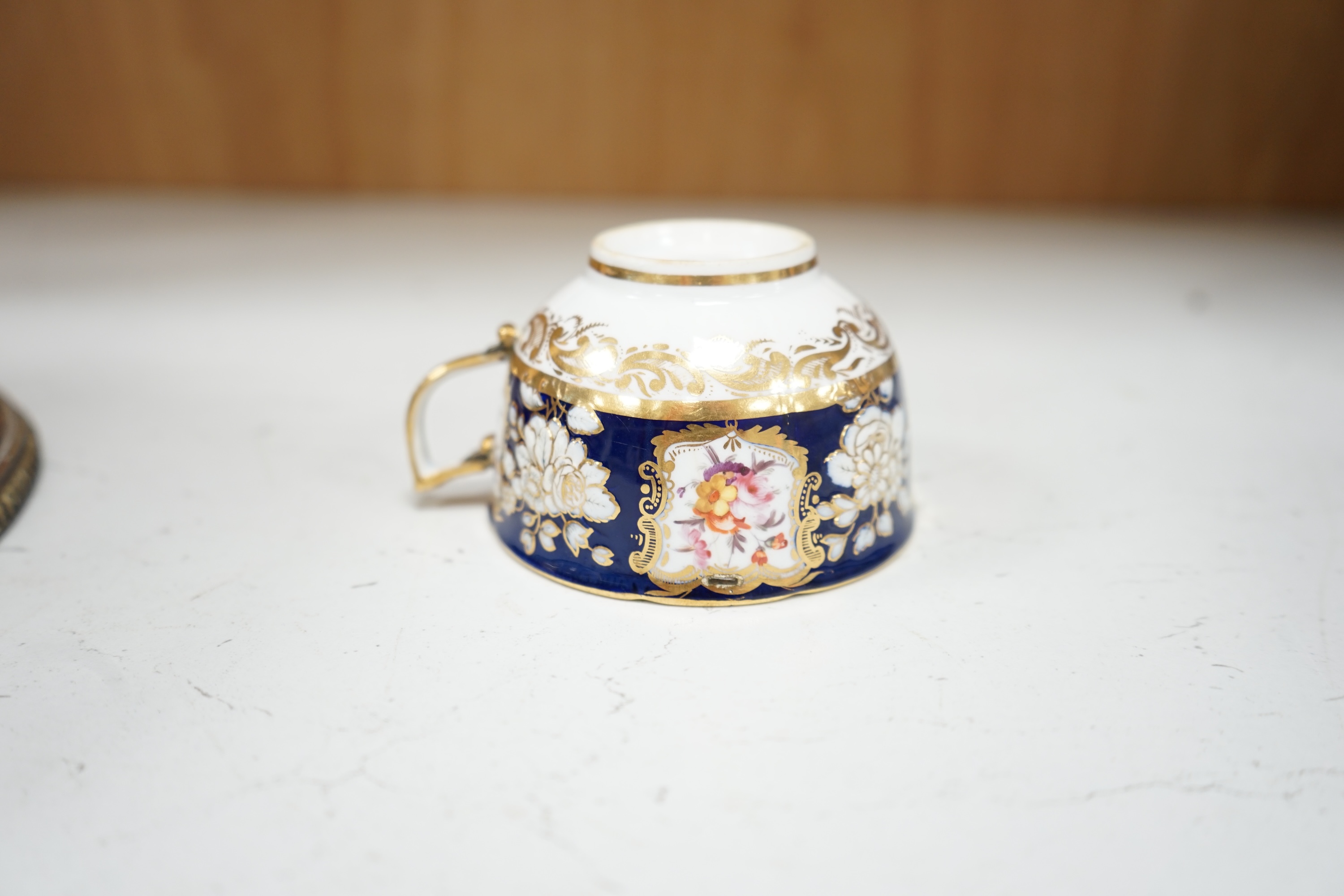 An early 19th century English porcelain tea service, possibly Coalport, moulded in low relief with floral reserves and cobalt blue border. Condition - varies